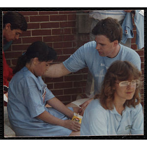 A man attends to a girl during the Battle of Bunker Hill Road Race