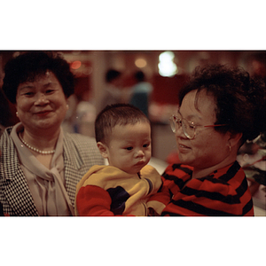 Guests and a baby at the Chinese Progressive Association's 15th Anniversary Celebration