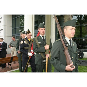 Four men in military uniform march at the Veterans Memorial groundbreaking ceremony