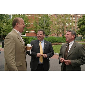 Three men converse at the Veterans Memorial groundbreaking ceremony