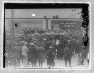 Crowd scene with Blackstone and Wahl advertisements