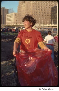 MUSE concert and rally: MUSE staff member collection donations in a red trash bag