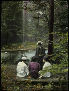 George W. Cable Garden (woman on stone bench talking with standing elderly man)