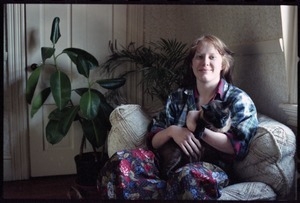 Amy Carter: half-length portrait, seated with Siamese cat in her Brown University apartment