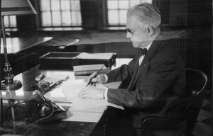 Hugh P. Baker working at his office desk