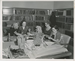 Women volunteers wrapping gifts for patients
