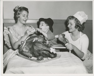 Young client eating turkey leg at Thanksgiving celebration