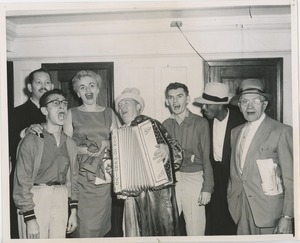 Accordionist and group singing
