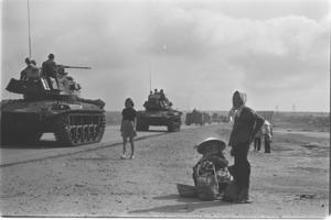 Henry Cabot Lodge visiting Quang Tin Province distributing candies to Vietnamese children, meeting with elders, and posing with a French newspaperwoman.