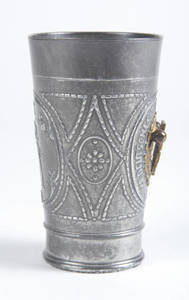 A pewter relief beaker, 1/4 liter, with brass 4F shield