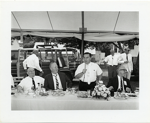 John F. Collins attending an outdoor luncheon event