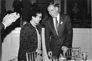 Mayor Raymond L. Flynn standing with Filipino President Corazon Aquino at at dinner table in Faneuil Hall