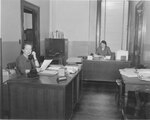 Suffolk University Law School Registrar's office staff: Registrar Catherine T. Judge (right) and Miss Foley (left), photograph, circa 1955