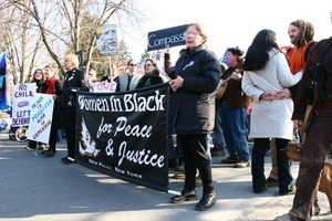 Marchers holding a banner for 'Women in Black for Peace and Justice': rally and march against the Iraq War