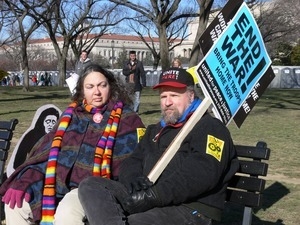 Protesters seated on a bench on the National Mall, marching against the War in Iraq