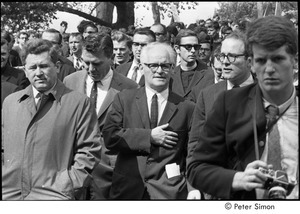 Resistance rally: demonstrators marching, William Sloane Coffin at right behind man with camera