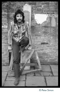 Cat Stevens: full-length portrait, seated by a laundry line on Carly Simon's back door patio