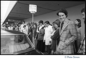 Devotees gathering around Swami Muktananda's car outside Los Angeles airport, seeing him off