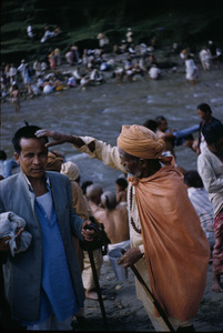 Priest blessing a pilgrim near the Baghmati river