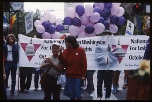 Newly-elected Congressional Representative Nancy Pelosi (red sweater) marching in the San Francisco Pride Parade in front of a banner for the National March on Washington for Lesbian and Gay Rights