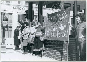 Antinuclear arms protesters with the AFSC Western Massachusetts banner, outside the Bank of Boston