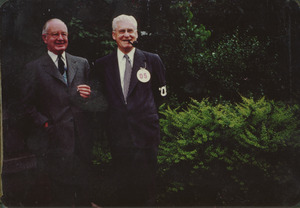 Two unidentified men standing outside