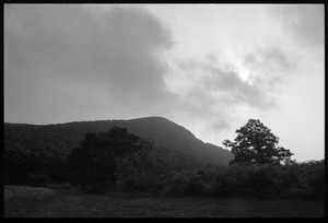 Stormy landscape with distant mountains, seen from the road