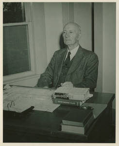William T. Simpson at desk