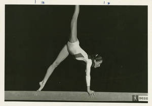 Joan Carey performing on the balance beam