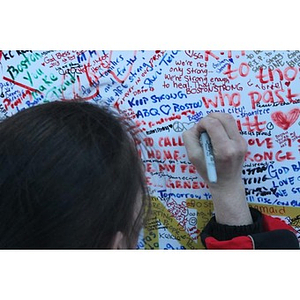 Person signing Boston Marathon memorial