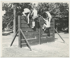 Army Air Corps cadets climbing up wall on Commando Course (ca. 1943)