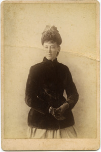 Three quarter-length studio portrait of Martha E. Dickinson