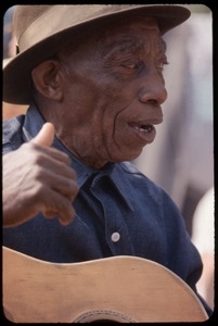 Mississippi John Hurt: in concert, playing guitar (at Newport?)