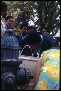 Rev. Ralph Abernathy drinking from a water fountain