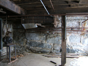 Piping and foundation wall by basement doorway