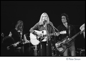 Joni Mitchell performing at the Harvard Square Theater, Cambridge, with the Rolling Thunder Revue