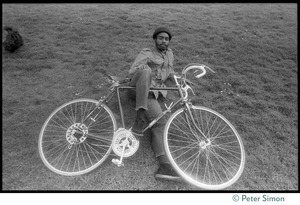 African American man lying of the ground with his bicycle, near 181 Vicente Street