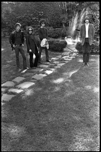 The Velvet Underground: (l.-r.) Lou Reed, Maureen Tucker, Doug Yule, and Sterling Morrison standing in a circle garden