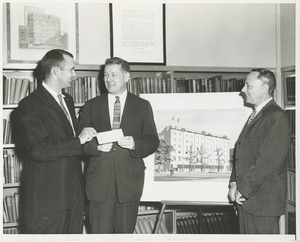 William Morianty, Queens Police officer handing a check to Willis C. Gorthy in front of prospective building plans