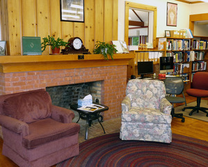 Rowe Town Library: interior view of seating by a fireplace