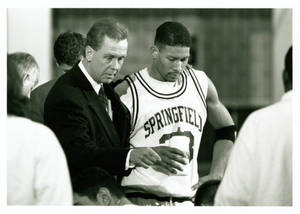 Coach Michael D. Theulen standing with Ivan Latimore in huddle (1995-1996)