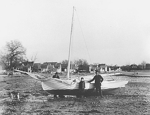 Benjamin Martin and son with sailboat on Blaney Beach