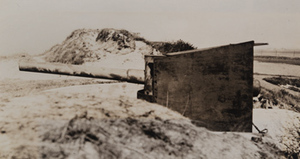 View of an abandoned German machine gun set up on a sand dune