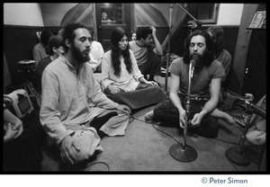 Amazing Grace in the recording studio, with Krishna Das seated on floor in lotus position, singing