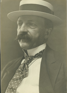 George E. Stone wearing polka dot tie and straw boater hat