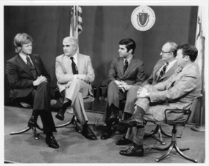 Robert C. Wood seated indoors with four men at Mount Wachusett Community College