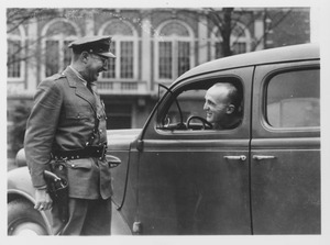 Campus police officer Tom Moran chats with a unidentified man in car