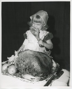 Little girl with turkey leg