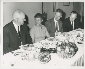 Sam Farnsworth with unidentified woman and men at Thanksgiving celebration