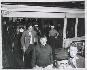 People disembark from ship